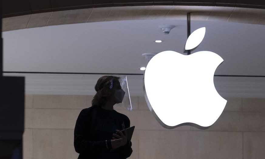 FILE - In this Feb. 5, 2021, file photo, an Apple store employee wears personal protective equipment in New York. At an event on Monday, June 7, 2021, Apple unveiled a variety of incremental improveme ...