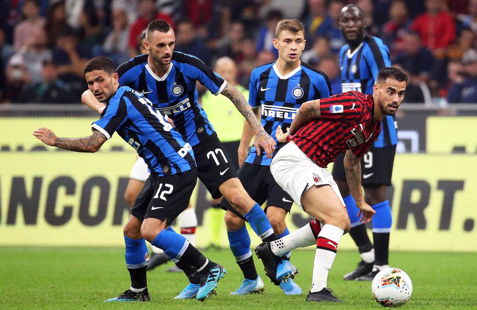 epa07860141 Milan&#039;s Suso (front R) in action against Inter players (L-R) Stefano Sensi, Marcelo Brozovic, and Nicolo Barella during the Italian Serie A soccer match between AC Milan and Inter Mil ...