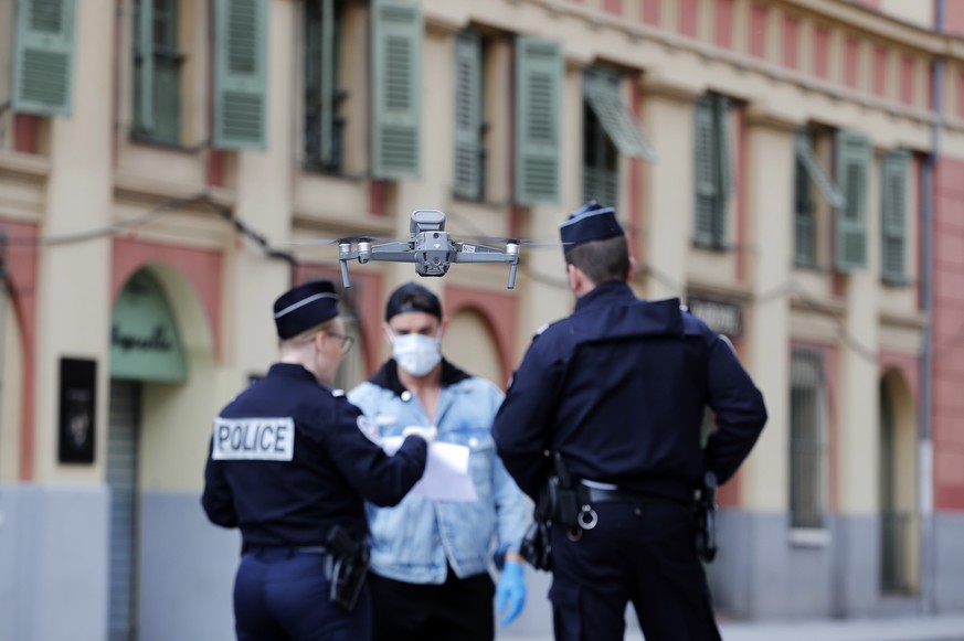 epa08315916 French policemen use a drone for reminding citizens of the SARS-CoV-2 coronavirus confinement measures in Nice, southern France, 23 March 2020. France is under lockdown in an attempt to st ...