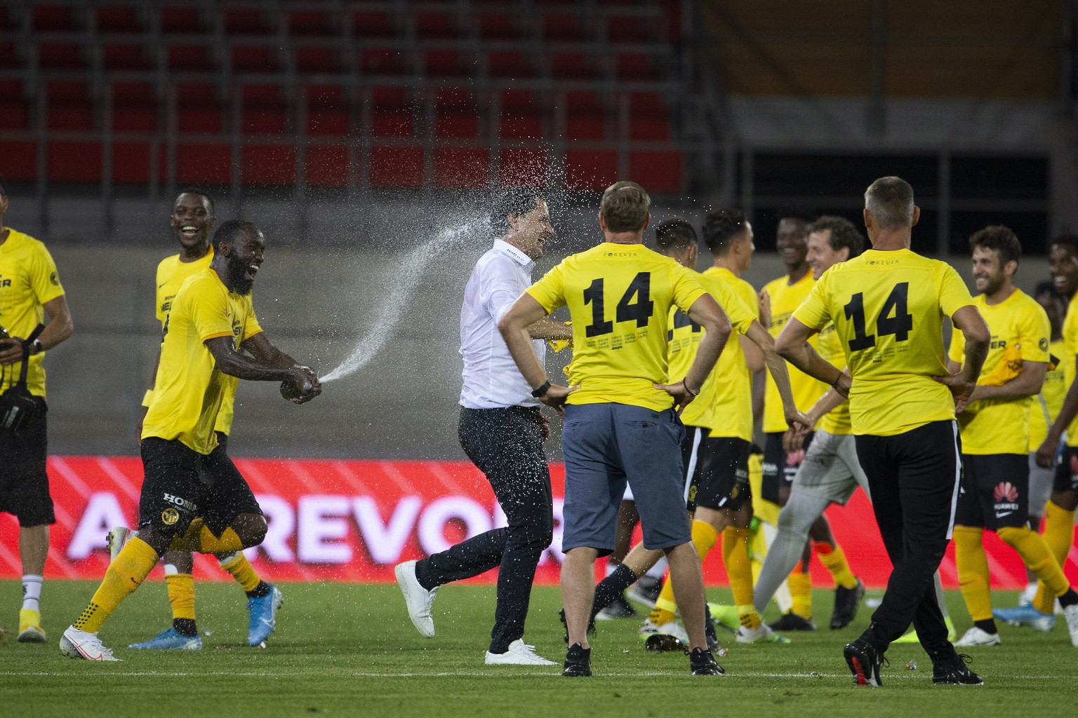 Young Boys&#039; players celebrate title as Swiss champion with of sparkling wine, after the Super League soccer match between FC Sion and BSC Young Boys, at the Stade de Tourbillon stadium, in Sion,  ...