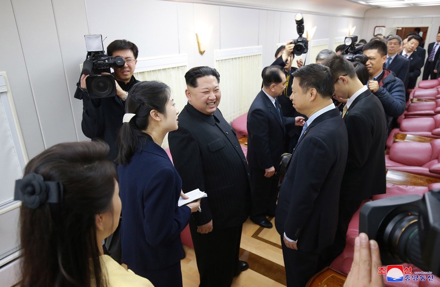 In this March 27, 2018, photo, North Korean leader Kim Jong Un, center left, talks with Song Tao, the head of China&#039;s ruling Communist Party&#039;s International Liaison Department, in a train in ...