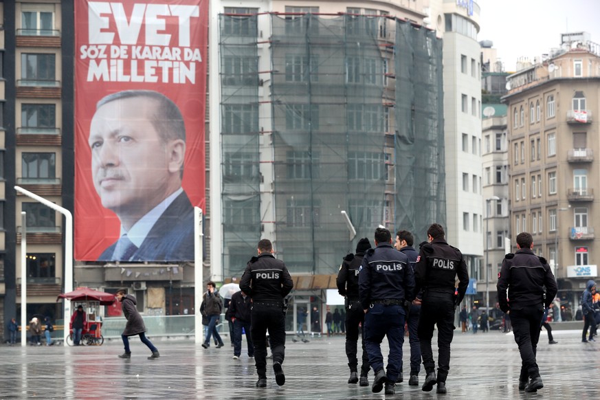epa05847271 People walk in front of a giant poster of Turkish President Recep Tayyip Erdogan reading &#039;Vote Yes, only public can speak and make a decision&#039; at Taksim Square in Istanbul, Turke ...