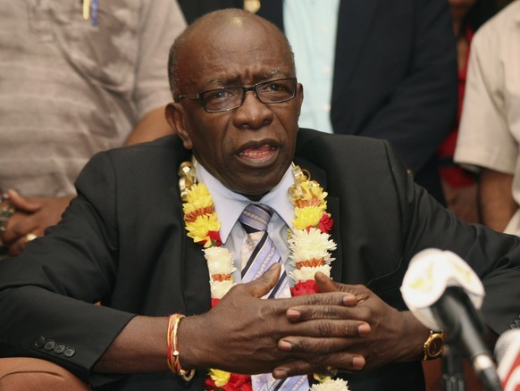 FILE - In this June 2, 2011, file photo, suspended FIFA executive Jack Warner gestures during a news conference at the airport in Port-of-Spain, Trinidad and Tobago. Interpol added six men with ties t ...