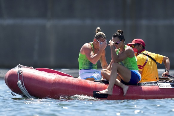Spela Ponomarenko Janic, left, and Anja Osterman of Slovenia react after flipping their boat while competing in the women&#039;s kayak double 500m semifinal at the 2020 Summer Olympics, Tuesday, Aug.  ...