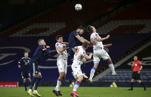 Scotland&#039;s Grant Hanley and Faroe Islands&#039; Gunnar Vatnhamar, right, battle for the ball during a World Cup 2022 group F qualifying soccer match between Scotland and Faroe Islands at Hampden  ...