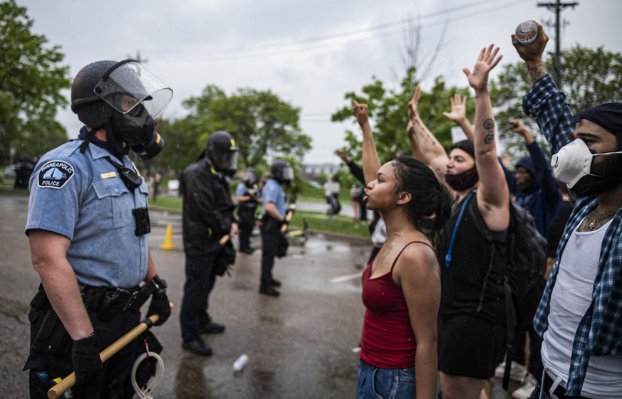 Protesters and police face each other during a rally for George Floyd in Minneapolis on Tuesday, May 26, 2020. Four Minneapolis officers involved in the arrest of the black man who died in police cust ...