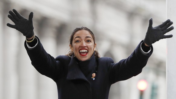U.S. Rep. Alexandria Ocasio-Cortez, (D-New York) waves to the crowd as she steps onto the stage at the Women&#039;s Unity Rally organized by Women&#039;s March NYC in Lower Manhattan, Saturday, Jan. 1 ...