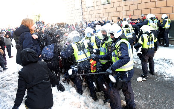 Counter-protesters throw snowballs at police who are keeping them away from a demonstration organised by The Nordic Resistance Movement (Nordiska motstandsrorelsens) in central Stockholm November 12,  ...