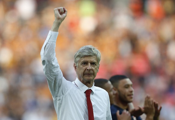 FILE - In this Saturday, May 17, 2014 file photo, Arsenal&#039;s manager Arsene Wenger punches the air in celebration of their win against Hull City at the end of their English FA Cup final soccer mat ...