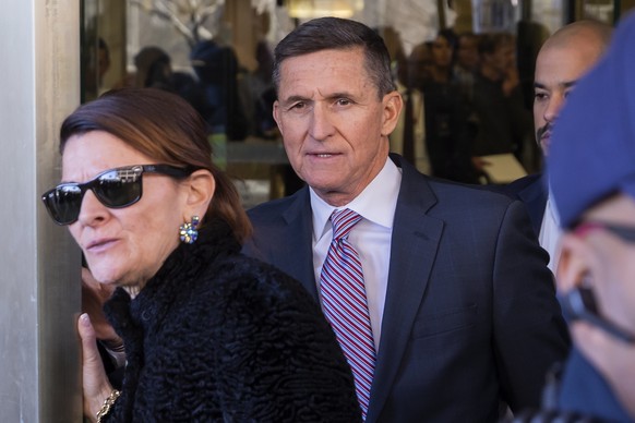 epa07238881 Former national security advisor Michael Flynn (C) leaves after a sentencing hearing at US District Court in Washington, DC, USA, 18 December 2018. Flynn plead guilty to lying to the FBI b ...