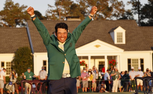 epa09129968 Hideki Matsuyama of Japan celebrates during the green jacket ceremony after winning the 2021 Masters Tournament at the Augusta National Golf Club in Augusta, Georgia, USA, 11 April 2021. T ...