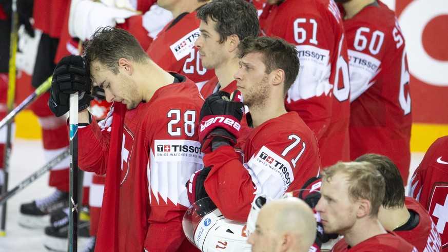 epa09245475 Swiss players react after the IIHF Ice Hockey World Championship 2021 quarter final game between Switzerland and Germany at the Olympic Sports Centre in Riga, Latvia, 03 June 2021. EPA/SAL ...