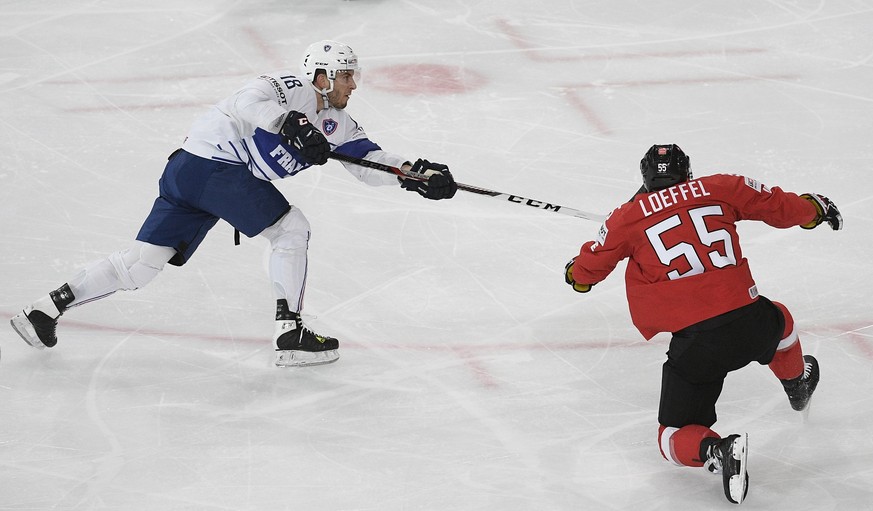 epa05953360 Yohann Auvitu of france (L) and Romain Loeffel during their Ice Hockey World Championship group B preliminary round match between Switzerland and France in Paris, France on Tuesday, May 9, ...