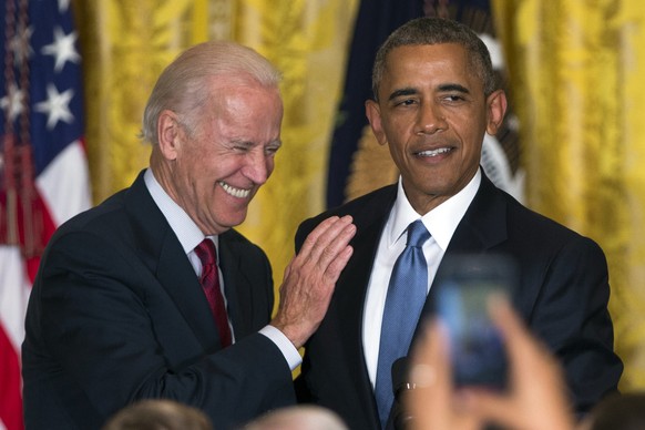 FILE - In this June 24, 2015 file photo Vice President Joe Biden and President Barack Obama speak in the East Room of the White House in Washington. President Barack Obama is the man in the middle as  ...