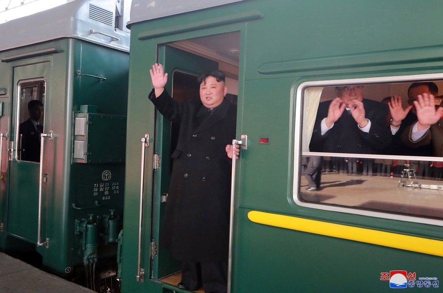 epaselect epa07391627 A photo released by the official North Korean Central News Agency (KCNA) shows North Korean leader Kim Jong-un (C) waving as he boards a train in Pyongyang, North Korea, 23 Febru ...