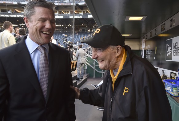 In this Wednesday, April 26, 2017 photo, Pittsburgh Pirates president Frank Coonelly talks with usher Phil Coyne before Coyne was honored in a pregame ceremony before a baseball game agains the Chicag ...