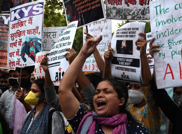 epa08722322 Jawaharlal Nehru University (JNU) students along with other demonstrators shout slogans holding placards during a protest against an alleged gang rape of a 19 years old Dalit girl in Uttar ...