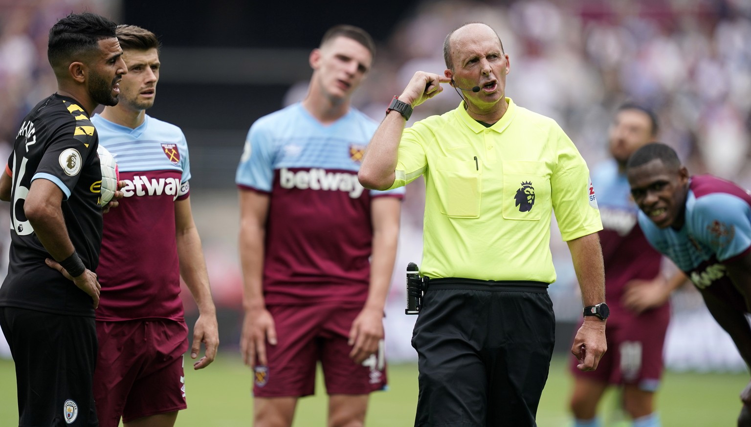 epaselect epa07766122 Referee Mike Dean (2-R) checks a decision from VAR during the English Premier League soccer match between West Ham and Manchester City at the London Stadium, London, Britain, 10  ...