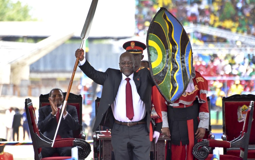 FILE - In this Nov. 5, 2015, file photo, Tanzania&#039;s President John Magufuli holds up a ceremonial spear and shield to signify the beginning of his presidency, shortly after swearing an oath durin ...