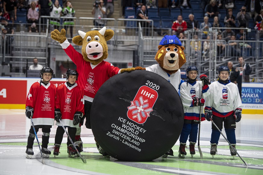 epa07604386 Macejko (R), official mascot of the IIHF Ice Hockey World Championship 2019, stands next to 2020 mascot Cooly (L) during the IIHF World Championship ice hockey final between Canada and Fin ...