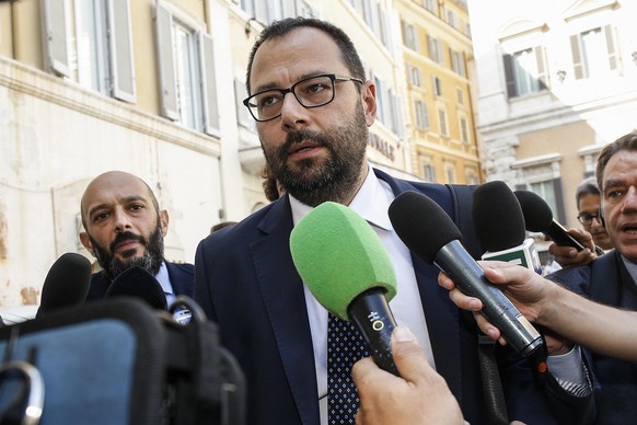 epa07804272 Five stars movement (M5S) Senate whip Stefano Patuanelli (C) talks with the press as he leaves the Lower house following a meeting with Italian Premier-designate Giuseppe Conte, in Rome, I ...