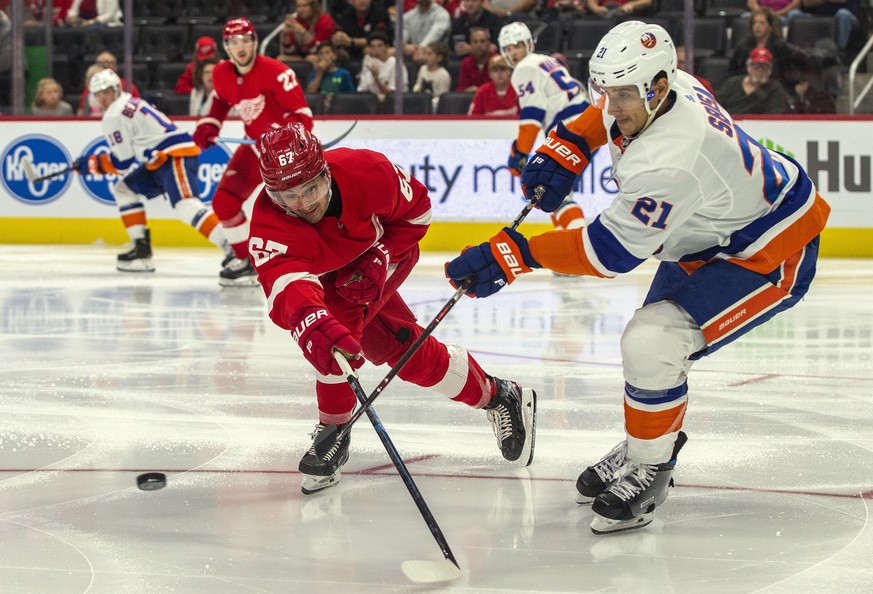 Detroit Red Wings forward Taro Hirose (67) challenges a pass from New York Islanders defenseman Luca Sbisa (21), of Italy, in the second period of a preseason NHL hockey game Friday, Sept. 20, 2019, i ...