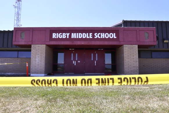 Police tape marks a line outside Rigby Middle School following a shooting there earlier Thursday, May 6, 2021, in Rigby, Idaho. Authorities said that two students and a custodian were injured, and a m ...