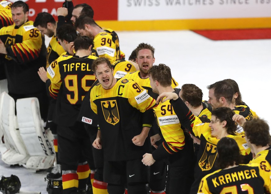 Germany&#039;s players celebrate their victory after the Ice Hockey World Championship group B match between Germany and Canada at the Arena in Riga, Latvia, Monday, May 24, 2021. (AP Photo/Sergei Gri ...