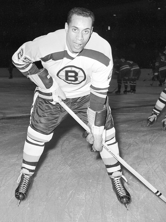 FILE - In this November 23, 1960 file photo, 25-year-old left wing Willie O&#039;Ree, the first black player of the National Hockey League, warms up in his Boston Bruins uniform, prior to the game wit ...