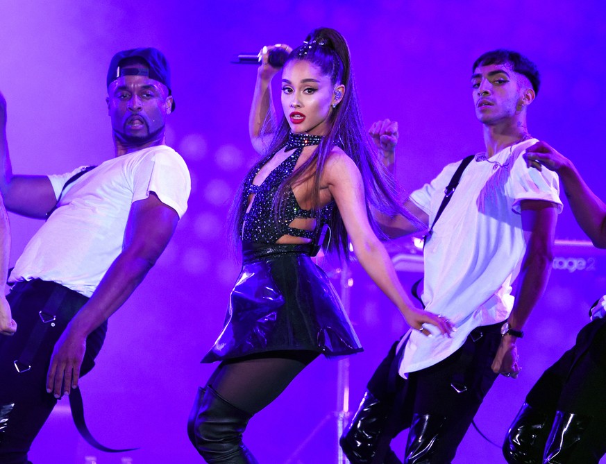 FILE - In this June 2, 2018 file photo, Ariana Grande, center, performs at Wango Tango in Los Angeles. Grande, Childish Gambino, Twenty One Pilots and The Strokes will headline this summer&#039;s Loll ...
