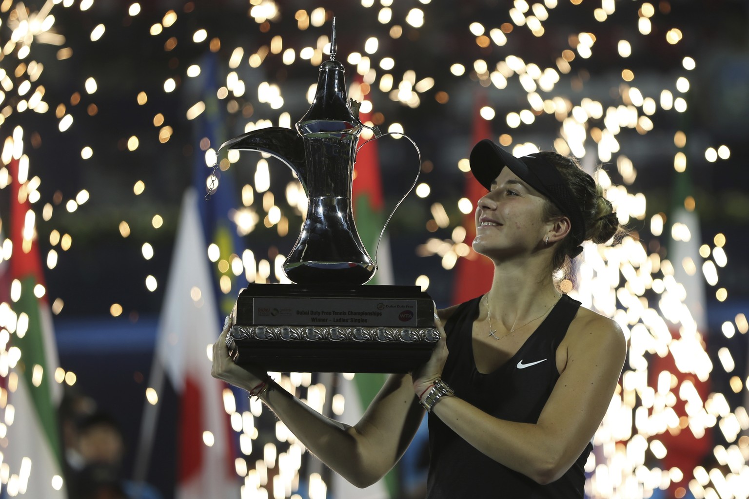 Switzerland&#039;s Belinda Bencic holds her trophy after defeating Czech Republic&#039;s Petra Kvitova during their final match of the Dubai Duty Free Tennis Championship in Dubai, United Arab Emirate ...