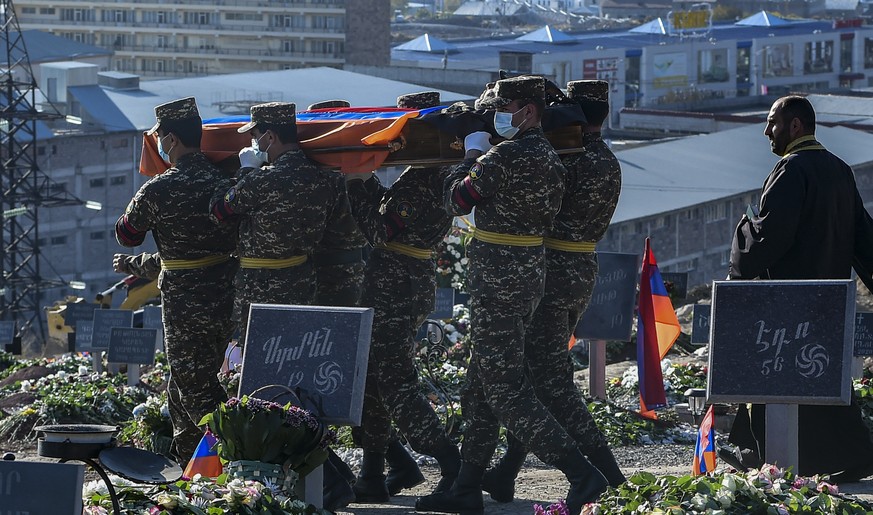 epa08817391 Armenian soldiers carry coffins with bodies of killed soldiers during war in the Nagorno-Karabakh Republic in Yerablur Military Memorial Cemetery in Yerevan, Armenia, 12 November 2020 (Iss ...