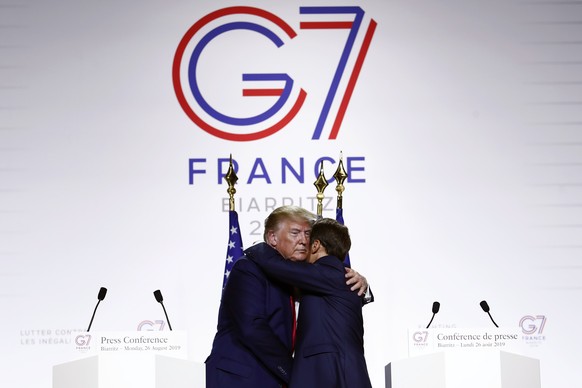 epa08308226 (FILE) - French President Emmanuel Macron (R) and US President Donald J. Trump (L) hug and pose as they hold a press conference on the closing day of the G7 summit in Biarritz, France, 26  ...