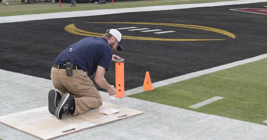 ESPN tecnichian Josh Kirkwood ajusts a camera in the end zone pylon before the NCAA College League USA College Football Playoff National Championship at Levi s Stadium on January 7, 2019 in Santa Clar ...