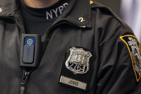 A police body camera is seen on an officer during a news conference on the pilot program involving 60 NYPD officers dubbed &#039;Big Brother&#039; at the NYPD police academy in the Queens borough of N ...