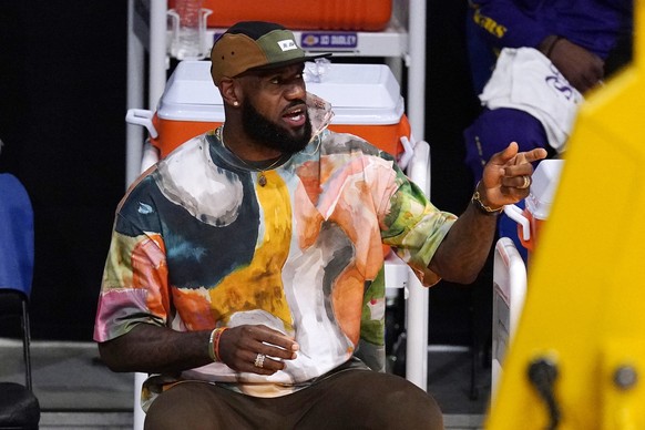 Los Angeles Lakers&#039; LeBron James watches from the bench during the first half of an NBA basketball game between the Lakers and the Utah Jazz Saturday, April 17, 2021, in Los Angeles. (AP Photo/Ma ...