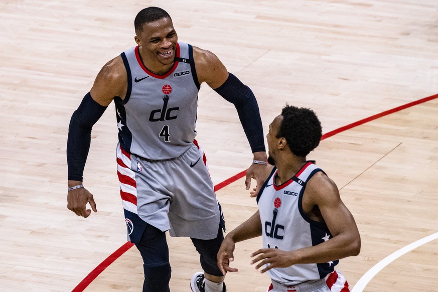 epa09166808 Washington Wizards guard Russell Westbrook and Washington Wizards guard Ish Smith celebrate after Smith dunked the ball after a pass from Westbrook during the second half of the NBA basket ...
