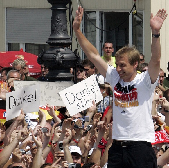 Juergen Klinsmann, head coach of Germany&#039;s national soccer team celebrates with fans at the &#039;Fan Mile&#039; in Berlin on Sunday July 9, 2006. Thousands of German soccer fans celebrate with t ...