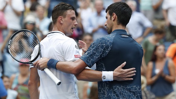 epa06979689 Novak Djokovic of Serbia (R) and Marton Fucsovics of Hungary (L) at the net after their match on the second day of the US Open Tennis Championships the USTA National Tennis Center in Flush ...