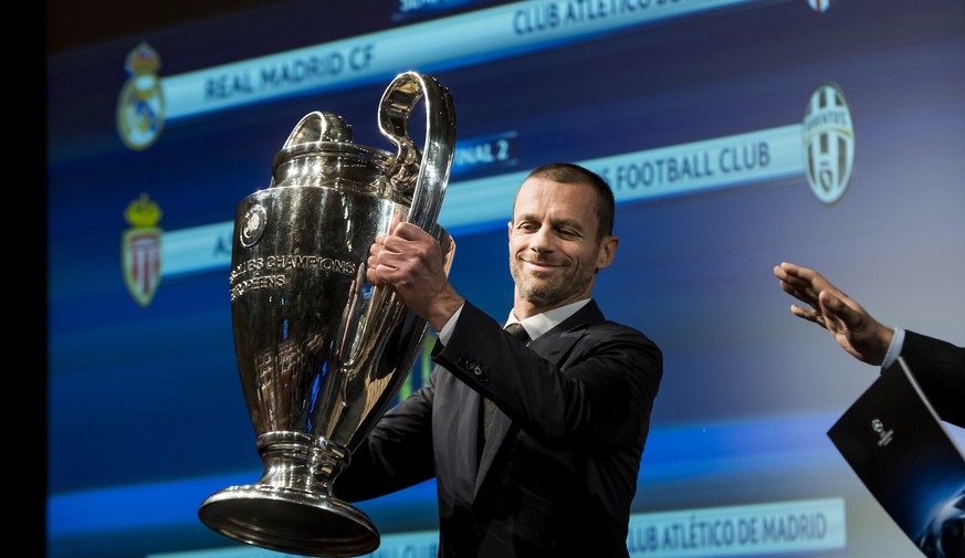 UEFA president Aleksander Ceferin holds the UEFA Champions League trophy during the semi-final draw of the UEFA Champions League 2016/17 at the UEFA Headquarters, in Nyon, Switzerland, Friday, April 2 ...