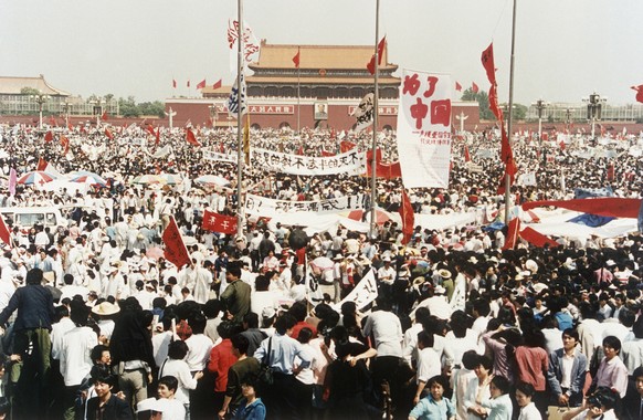 Thousands of pro democracy demonstrators in shown in Tiananmen Square, Wednesday, May 17, 1989, Beijing China. In the background is the Gate of Heavenly Peace. (AP Photo/Sadayuki Mikami)