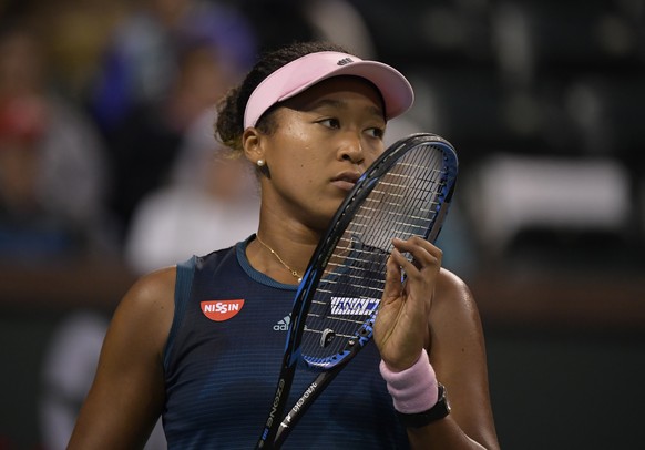 Naomi Osaka, of Japan, reacts after losing a game to Belinda Bencic, of Switzerland, at the BNP Paribas Open tennis tournament Tuesday, March 12, 2019 in Indian Wells, Calif. (AP Photo/Mark J. Terrill ...