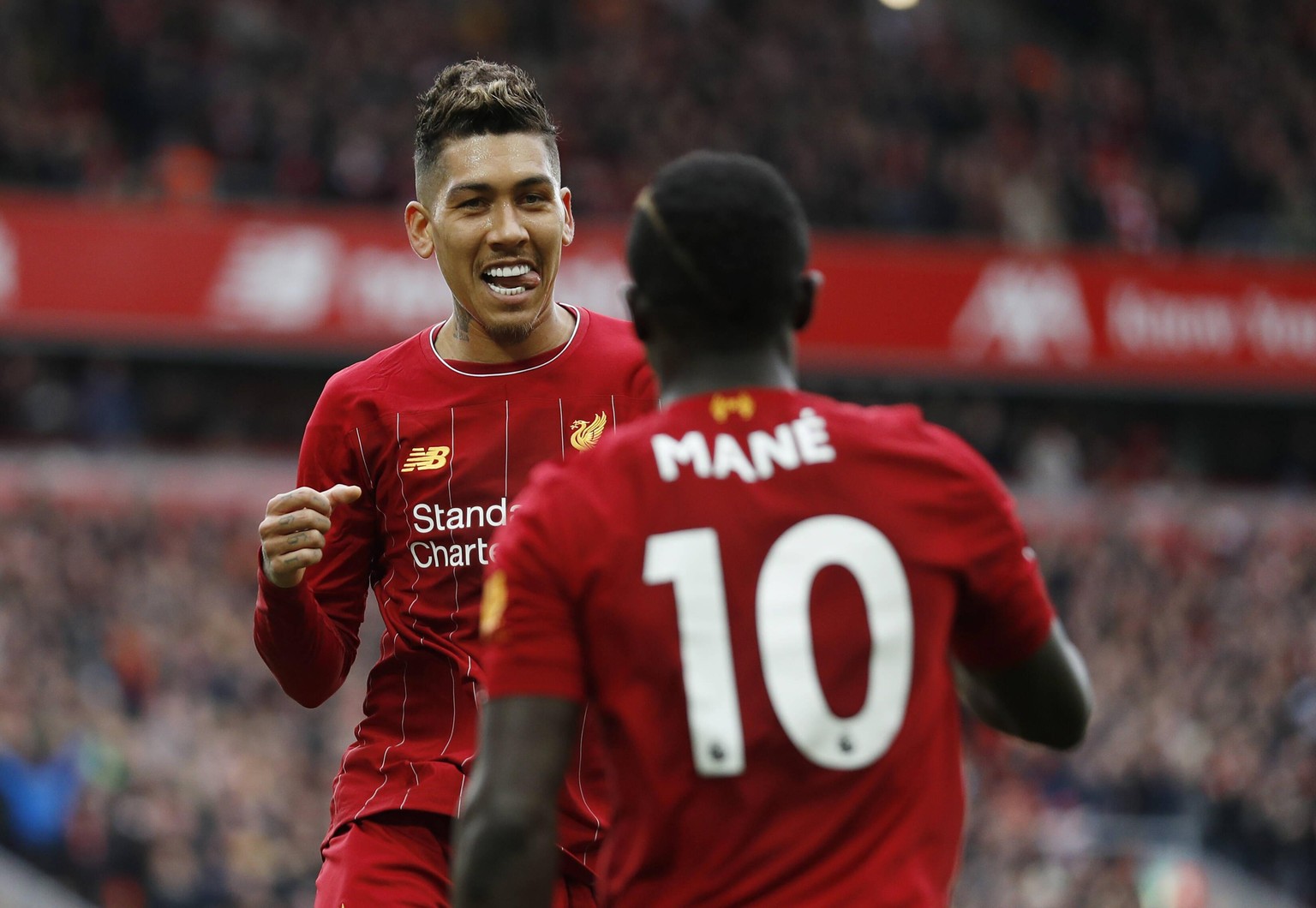 Roberto Firmino of Liverpool celebrates with scorer Sadio Mane of Liverpool during the Premier League match at Anfield, Liverpool. Picture date: 7th March 2020. Picture credit should read: Darren Stap ...