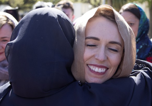 FILE - In this Sept. 24, 2020, file photo, New Zealand Prime Minister Jacinda Ardern is embraced as she arrives at the Al Noor mosque in Christchurch, New Zealand. Opinion polls indicate Ardern is on  ...