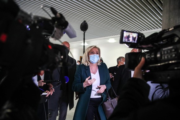 epa09001864 French member of Parliament and president of the Rassemblement National far-right party Marine Le Pen (C) talks to the press after a trial at the Tribunal De Grande Instance, in Nanterre,  ...