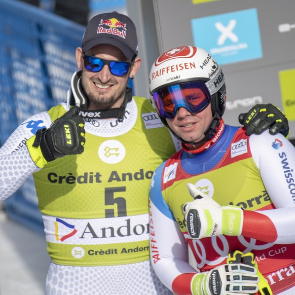 epa07433309 Beat Feuz of Switzerland (R) and Dominik Paris of Italy pose in the finish area during the men&#039;s Downhill race of the FIS Alpine Skiing World Cup finals in Soldeu-El Tarter, Andorra,  ...