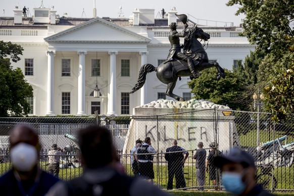 The White House is visible behind a statue of President Andrew Jackson in Lafayette Park, Tuesday, June 23, 2020, in Washington, with the word &quot;Killer&quot; spray painted on its base. Protesters  ...