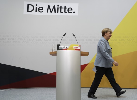 German Chancellor Angela Merkel leaves after a press conference after a board meeting of the Christian Democratic Union CDU in Berlin, Germany, Monday, Sept. 25, 2017, the day after the German parliam ...