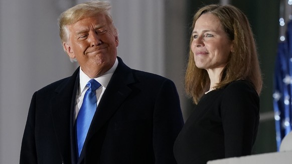 President Donald Trump and Amy Coney Barrett stand on the Blue Room Balcony after Supreme Court Justice Clarence Thomas administered the Constitutional Oath to her on the South Lawn of the White House ...