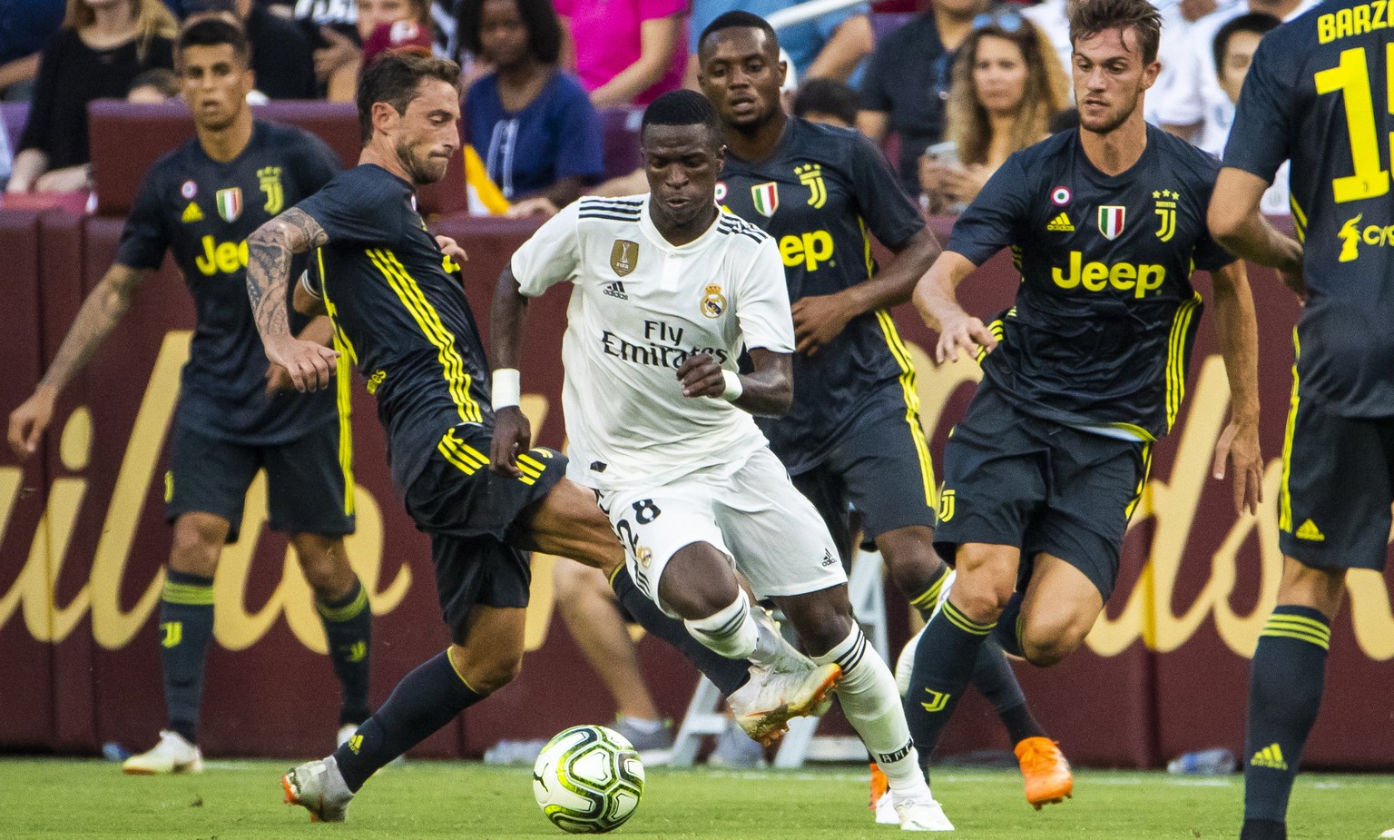 epa06928035 Read Madrid forward Vinicius Junior (C) drives through Juventus players during the second half of the International Champions Cup soccer match between Real Madrid and Juventus at FedExFiel ...